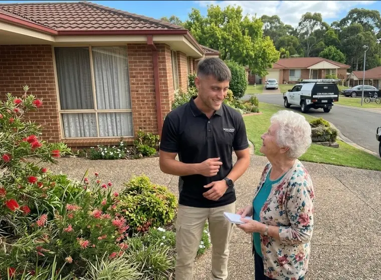 Ben talking a client through a job at her front door